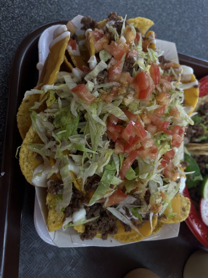 Nacho supremo loaded with beef, cheese, lettuce, tomato and crema
