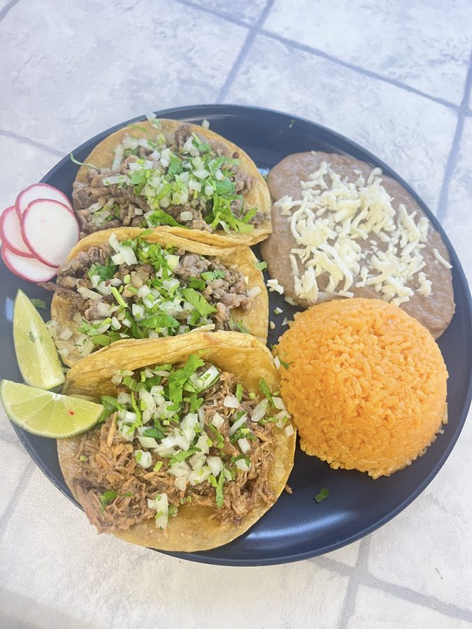 Three tacos served with rice and beans